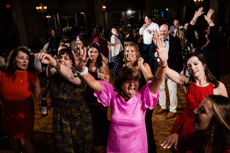 frontwedding02 - Stylus Weddings Wedding guests dancing together on a packed reception dance floor.