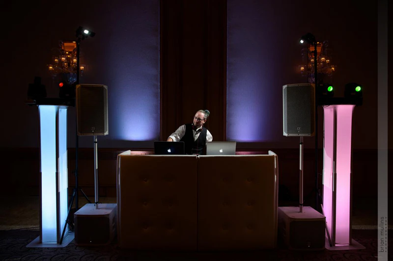 frontwedding04 - Stylus Weddings Wedding DJ setup with illuminated speaker towers and uplighting.