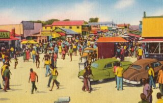 Historic street scene at Atlantic Beach, South Carolina, with crowds, businesses, and vintage cars during the resort’s mid-century peak.